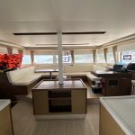 Lagoon 50 catamaran saloon with panoramic windows, lounge and dining area