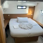 Excess 14 catamaran guest cabin with double bed and panoramic hull windows