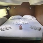 Spacious aft cabin aboard the Lagoon 380 catamaran with double berth and storage