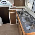 Fully equipped galley aboard the Lagoon 380 catamaran with practical workspace and storage